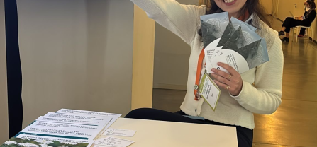 A young woman holding CoCo Flyer into the camera. 